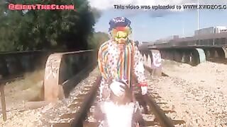 Clown almost gets hit by train while getting blowjob
